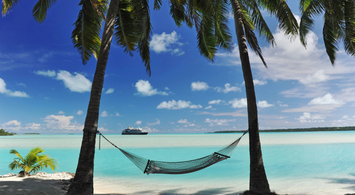 hammock tied between two trees with cruise shop in background