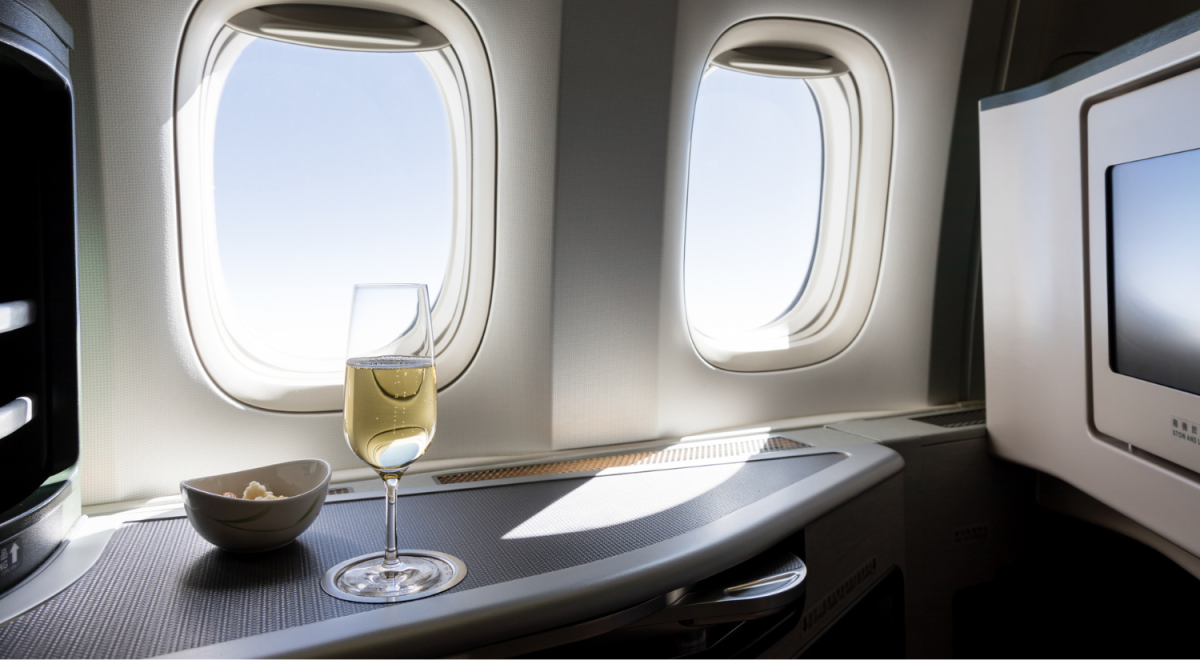 glass of champage beside plane window