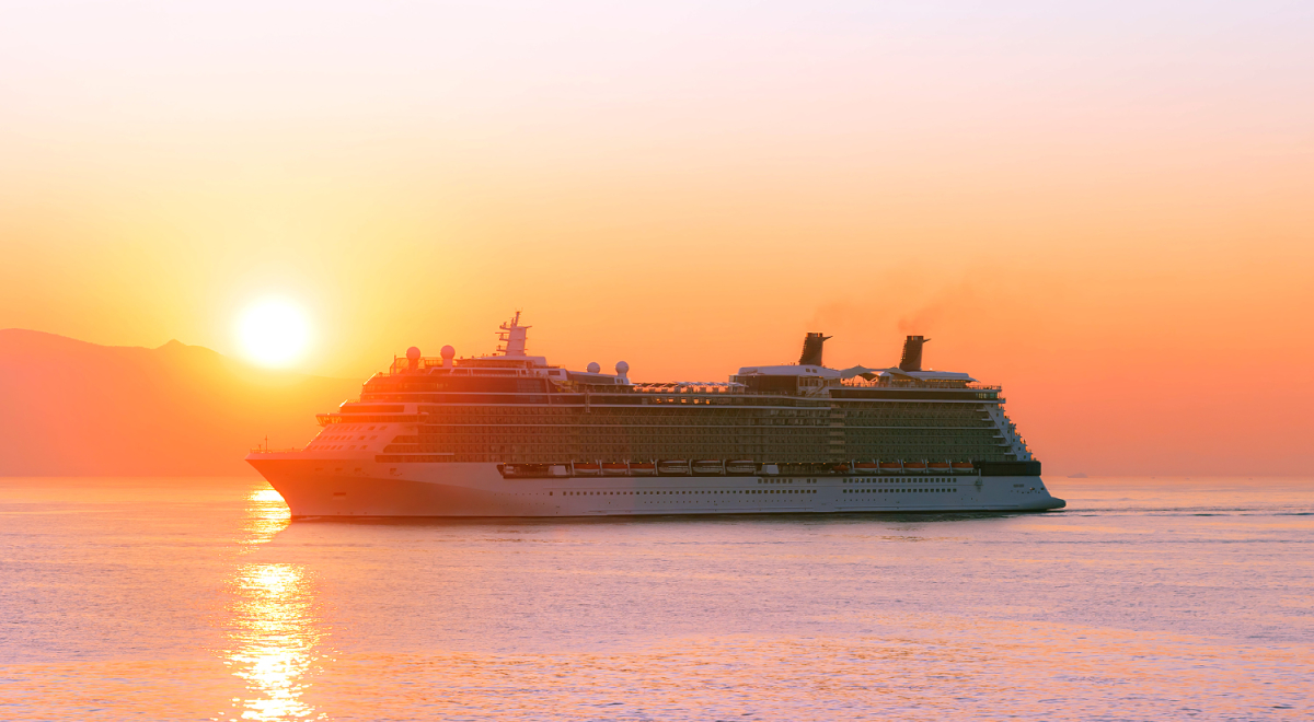 A cruise sailing at sunset