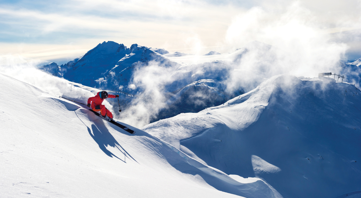 A skier carving through fresh powder at one of the best ski resorts in Canada