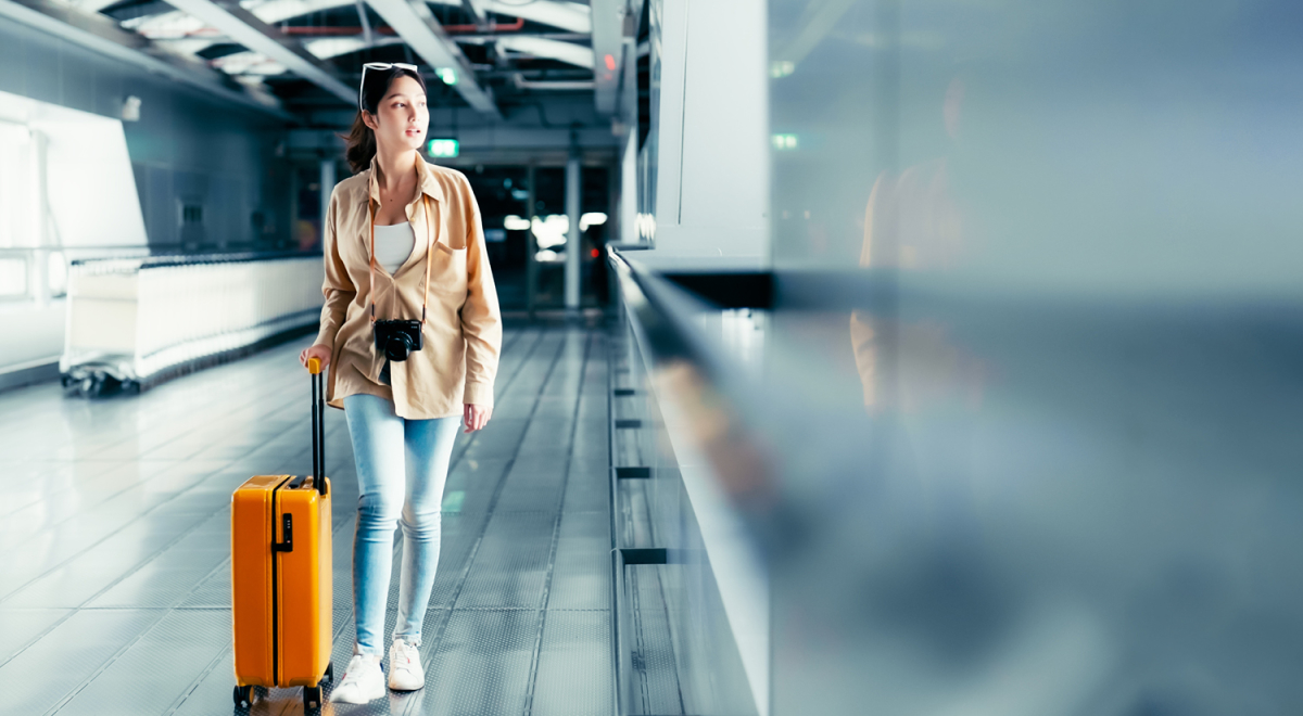 A woman travelling to a beach destination with just a carry-on