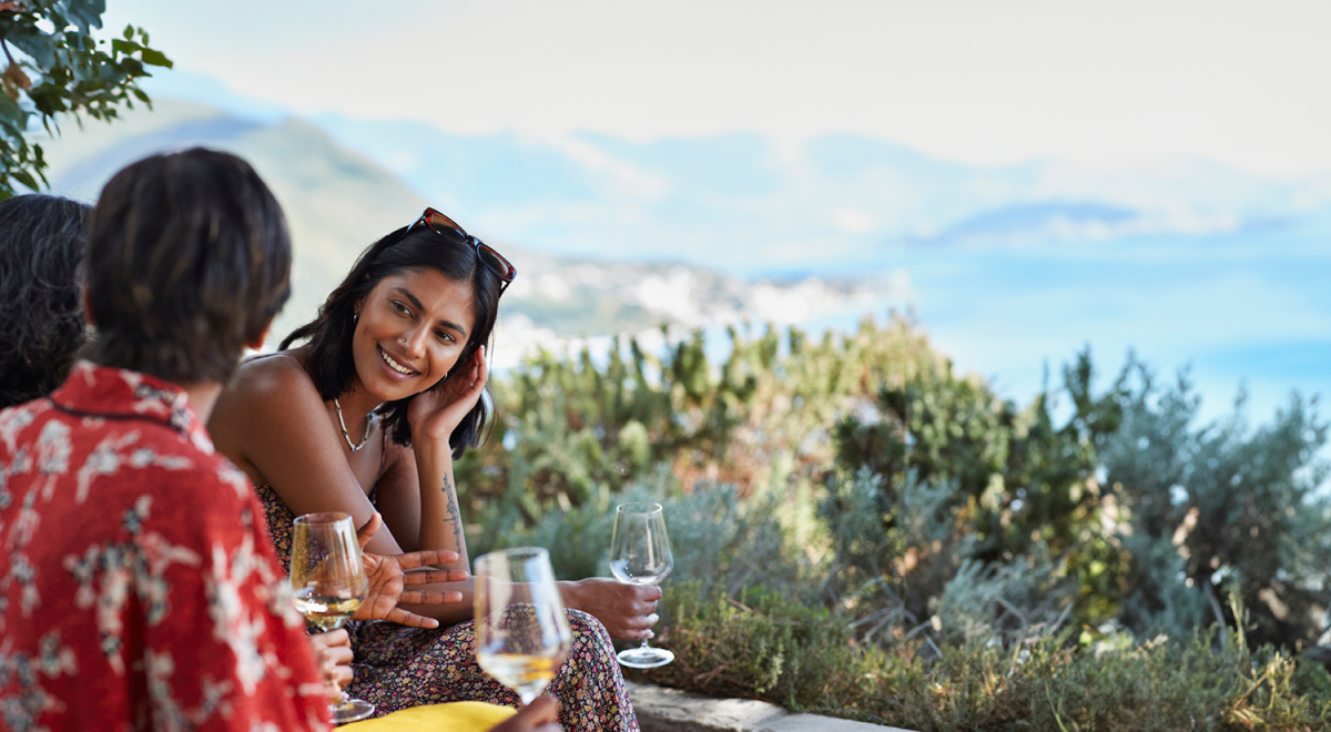 A small group of friends enjoying a glass of wine and taking in the views of their destination