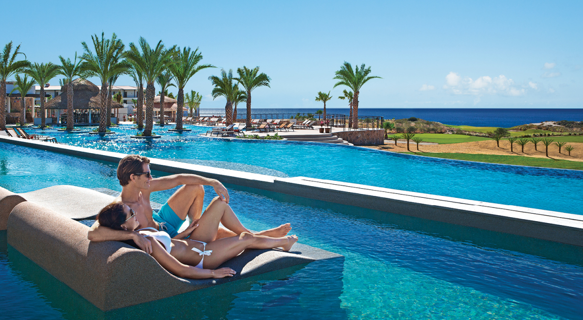 A couple relaxing at an adults-only resort in Los Cabos