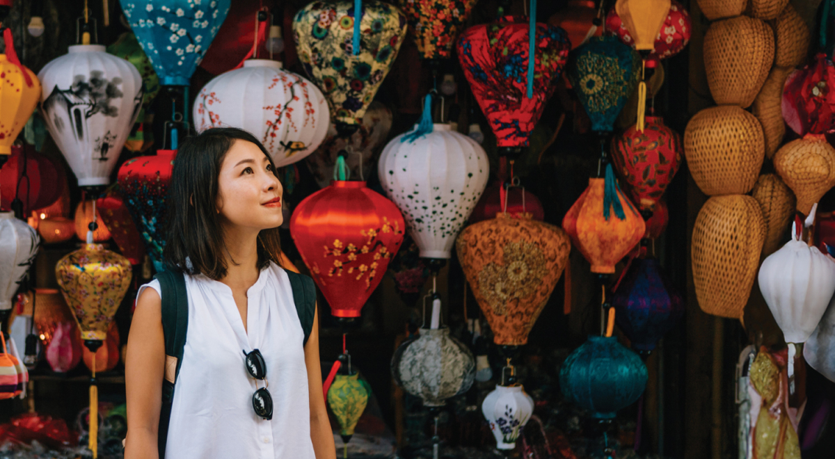 Asian woman standing in front of a display of lanterns
