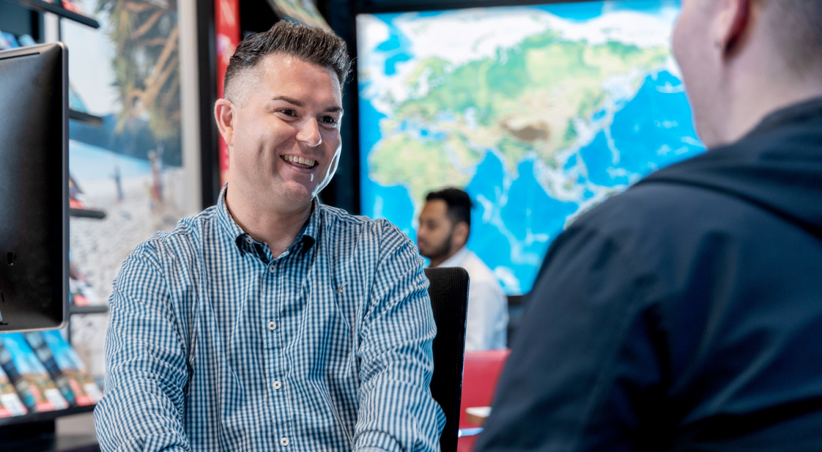 Flight Centre Travel Expert helping a customer