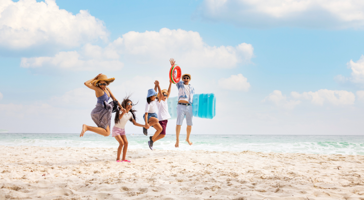 Family jumping happily on a beach