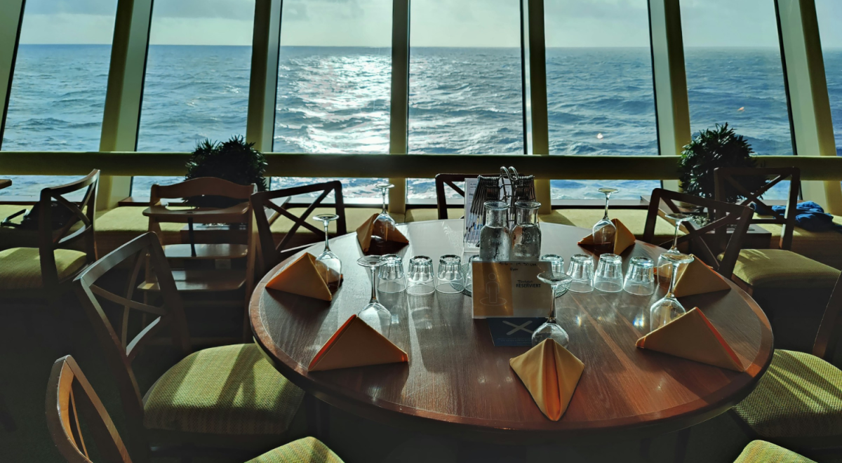 A cruise ship's dining table overlooking the sea