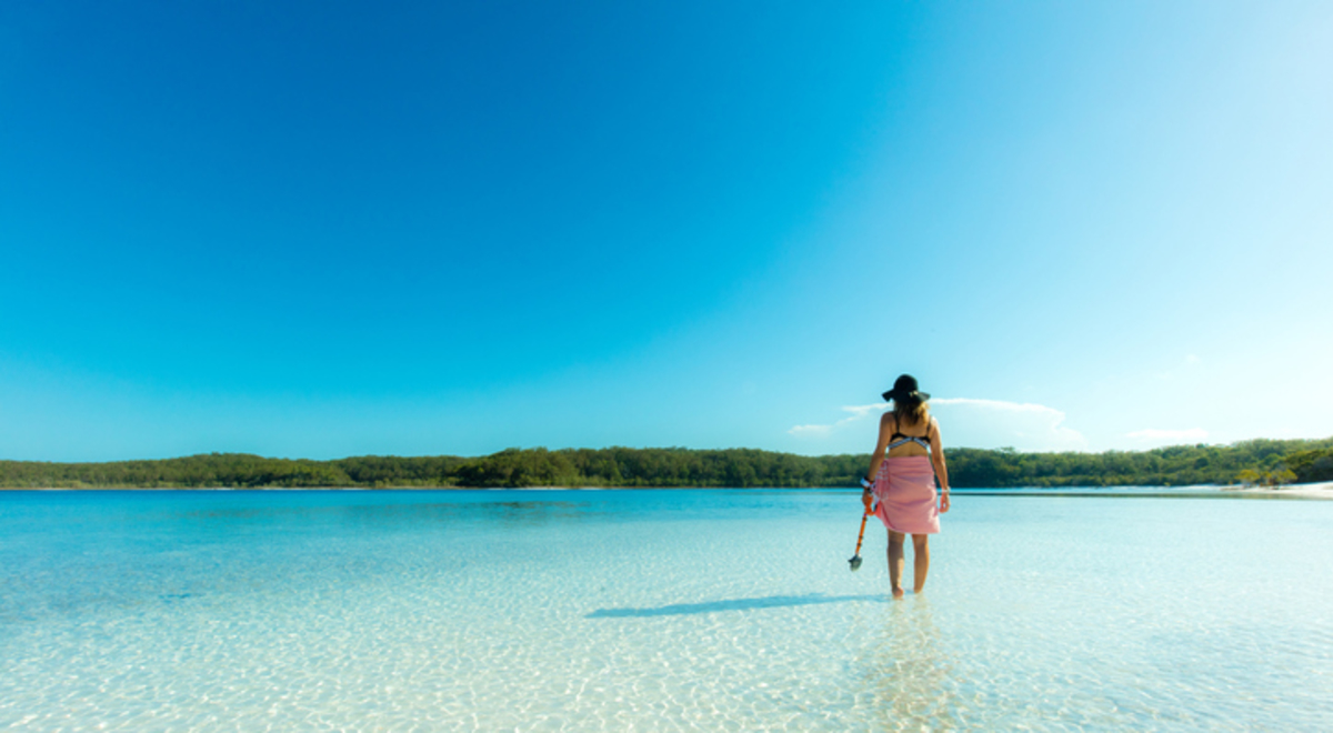 Single Person standing in shallow clear water looking out
