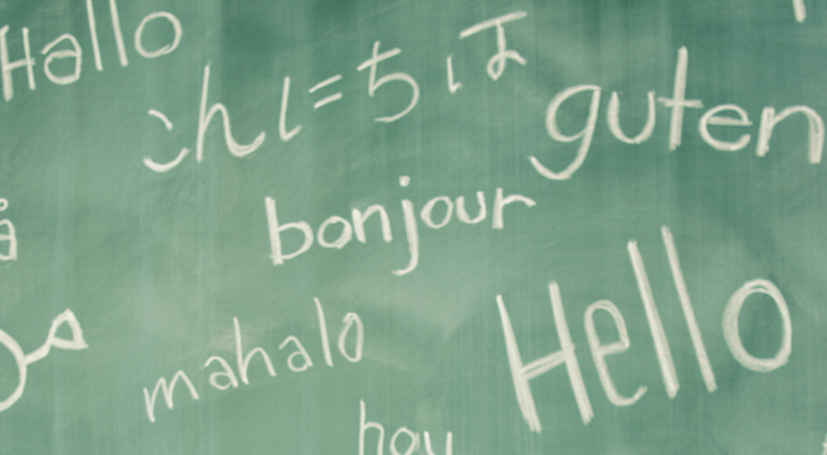 "Hello" written on a chalkboard and translated into different languages