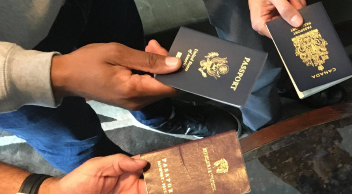 hands in a circle holding different nationality passport