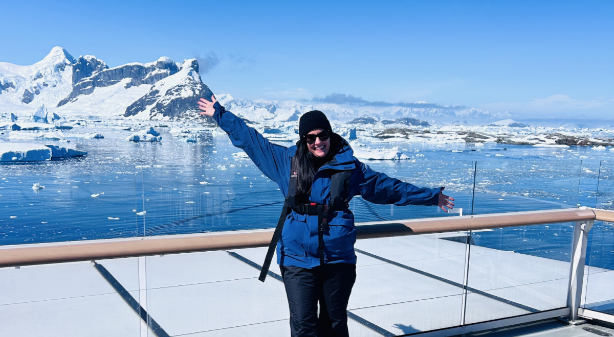 Heidi onboard with an iceberg behind her