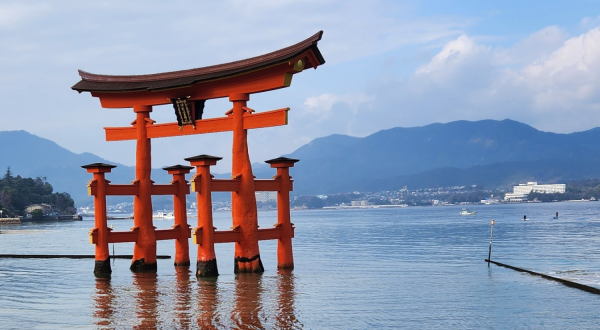 A traditional torii gate surrounded by calm lake waters