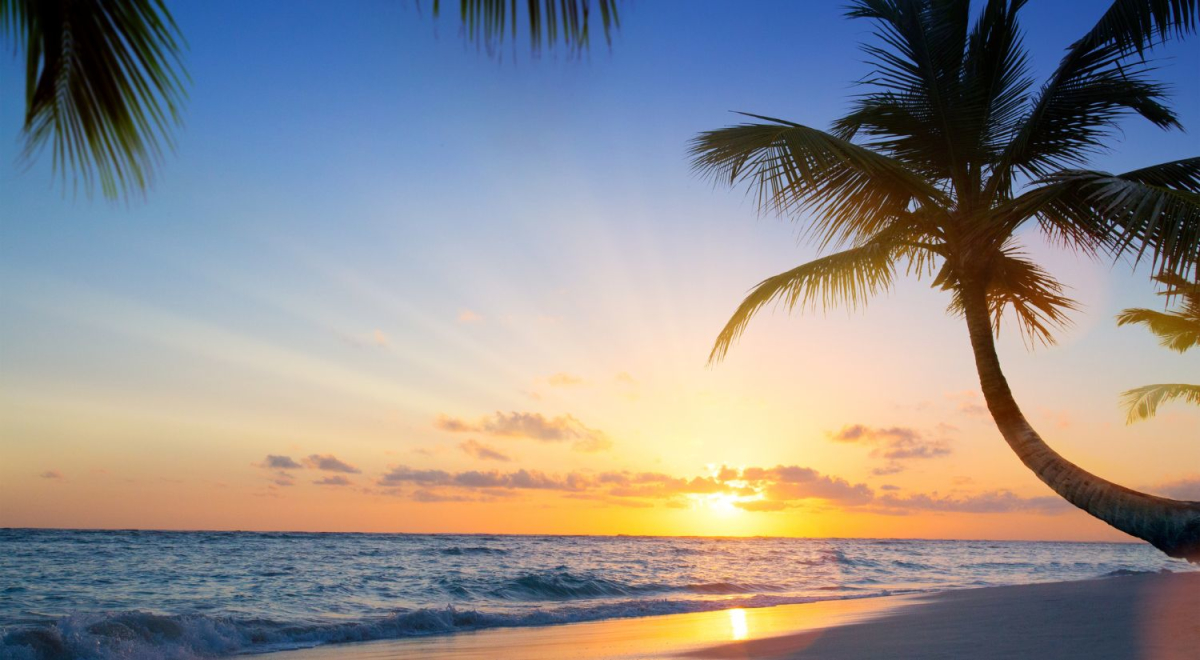 The sun setting over the South Pacific ocean from a beach in Fiji