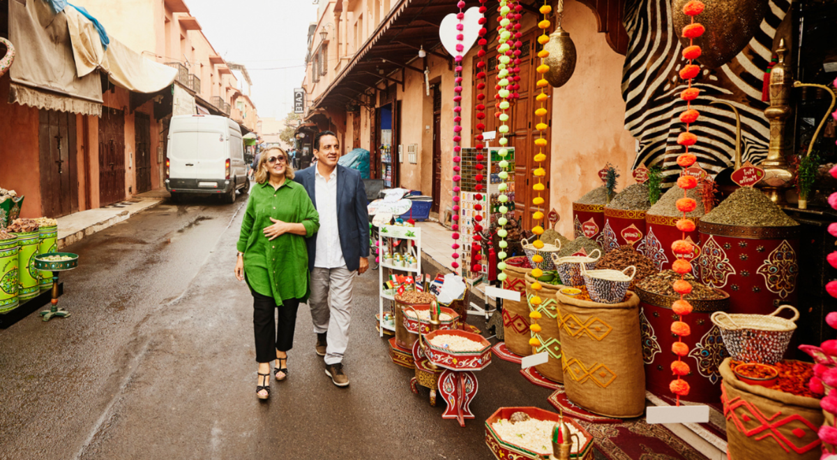 tourists walking past shops on local town street