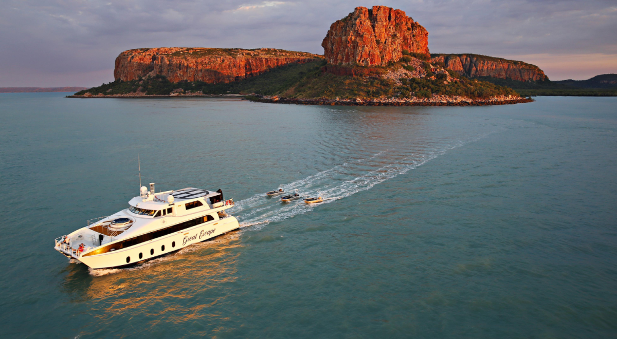 A cruise ship sailing off the rocky coast of Kimberley, Western Australia
