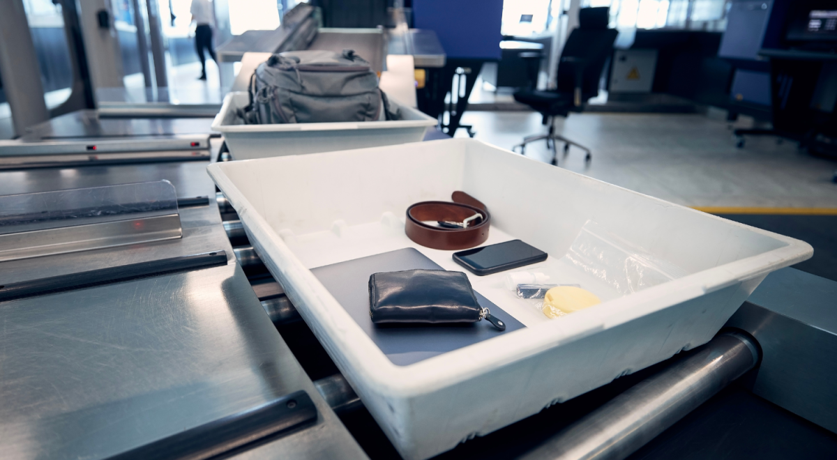 white tray full of  collected items from people who underwent a security check