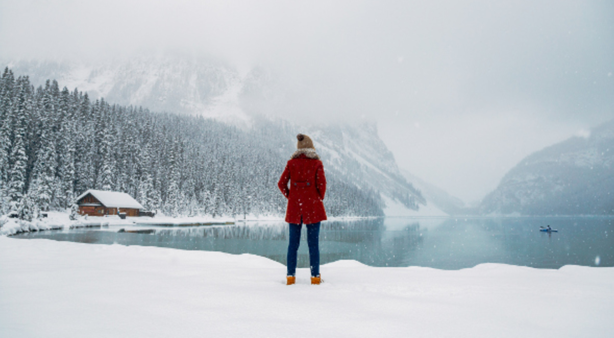 Woman enjoying snow and frozen lake