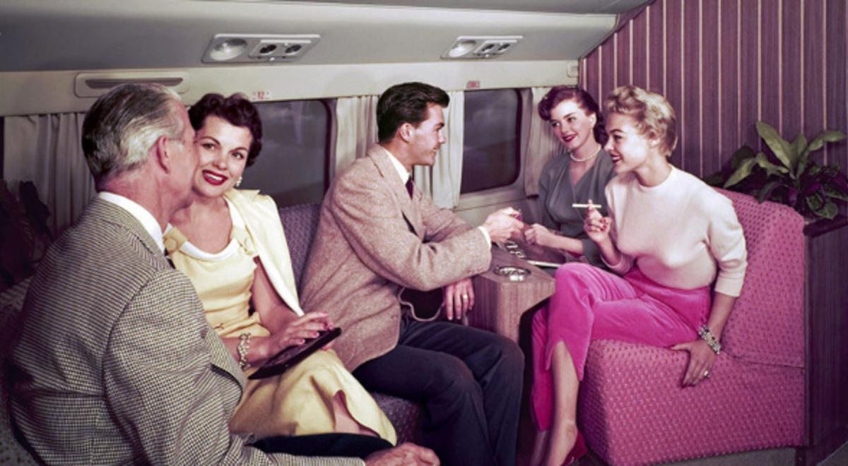 Group of middle-class passengers smoking and conversing on flight in the 90's