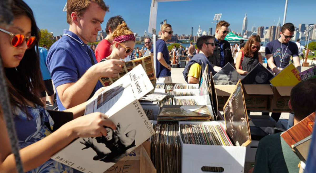people look through boxes of records at a flea market in Buswick New York