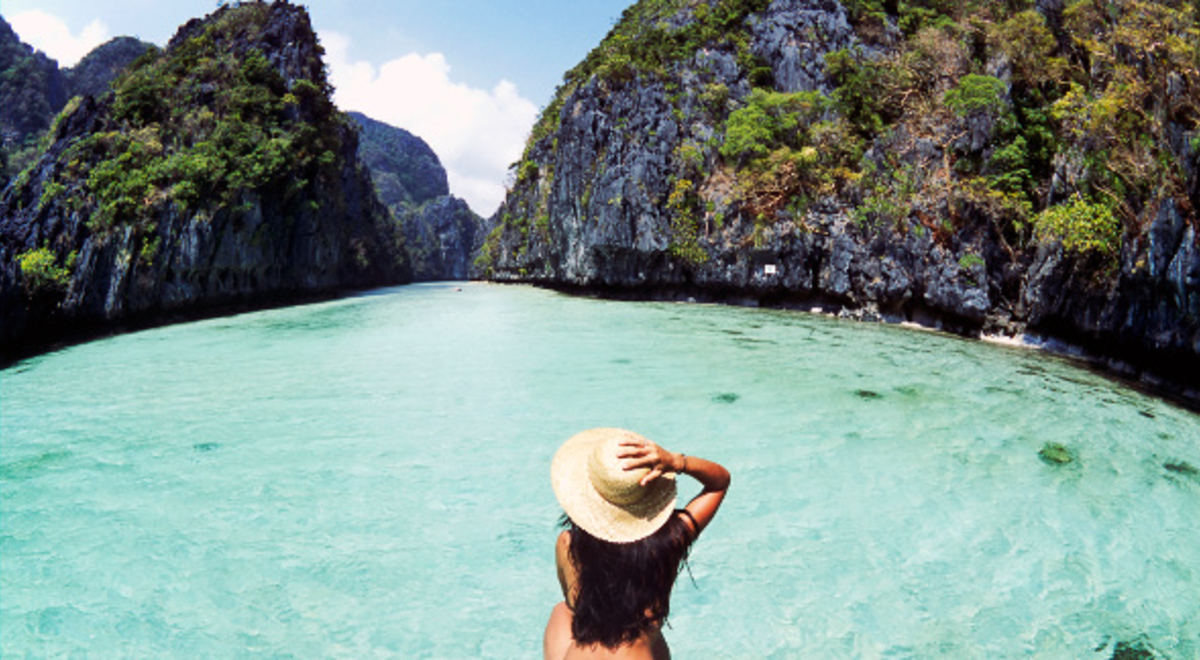 Woman swimming in the clear blue water at the Philippines 