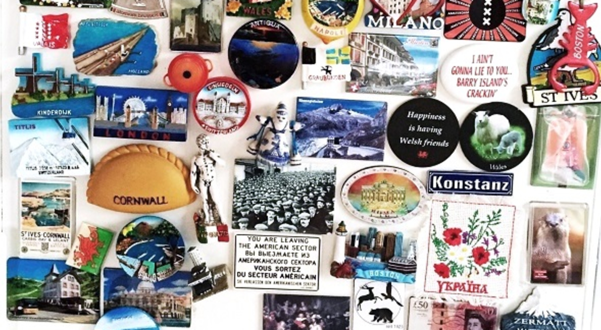 Colourful destination magnets fill the space on a fridge. 