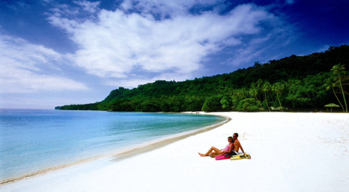 Couple enjoying view of the ocean from the shore