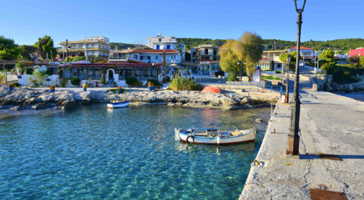 Clear blue water and village in Aegina, Greece 