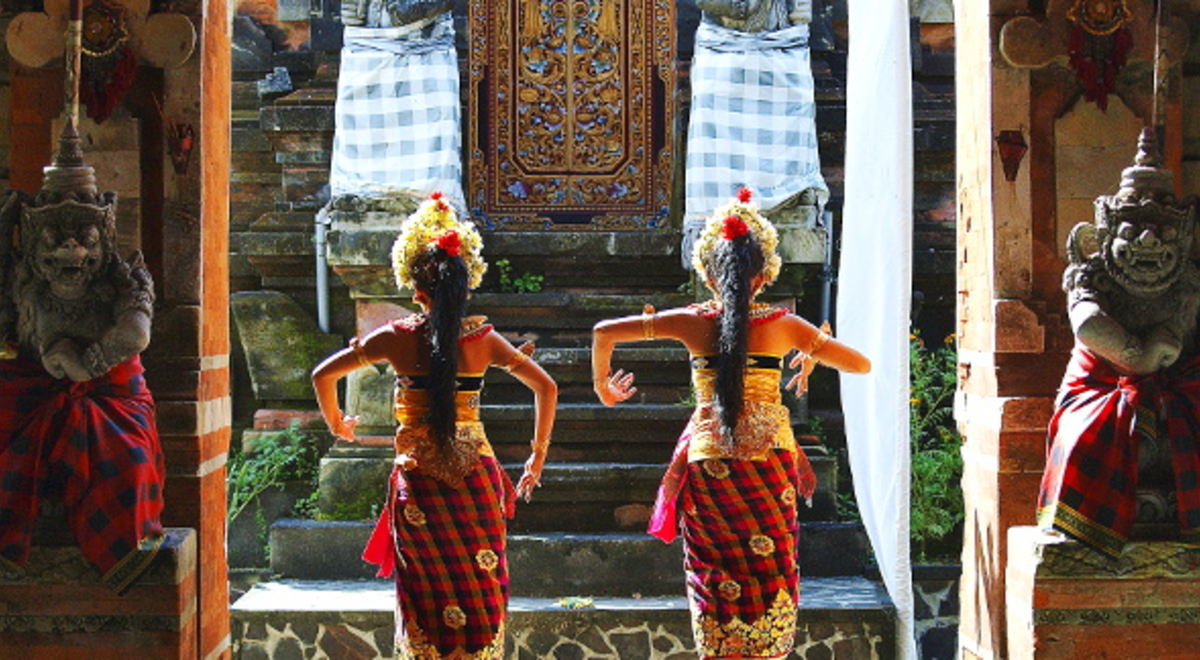Two Bali dancers dangling alongside two statues