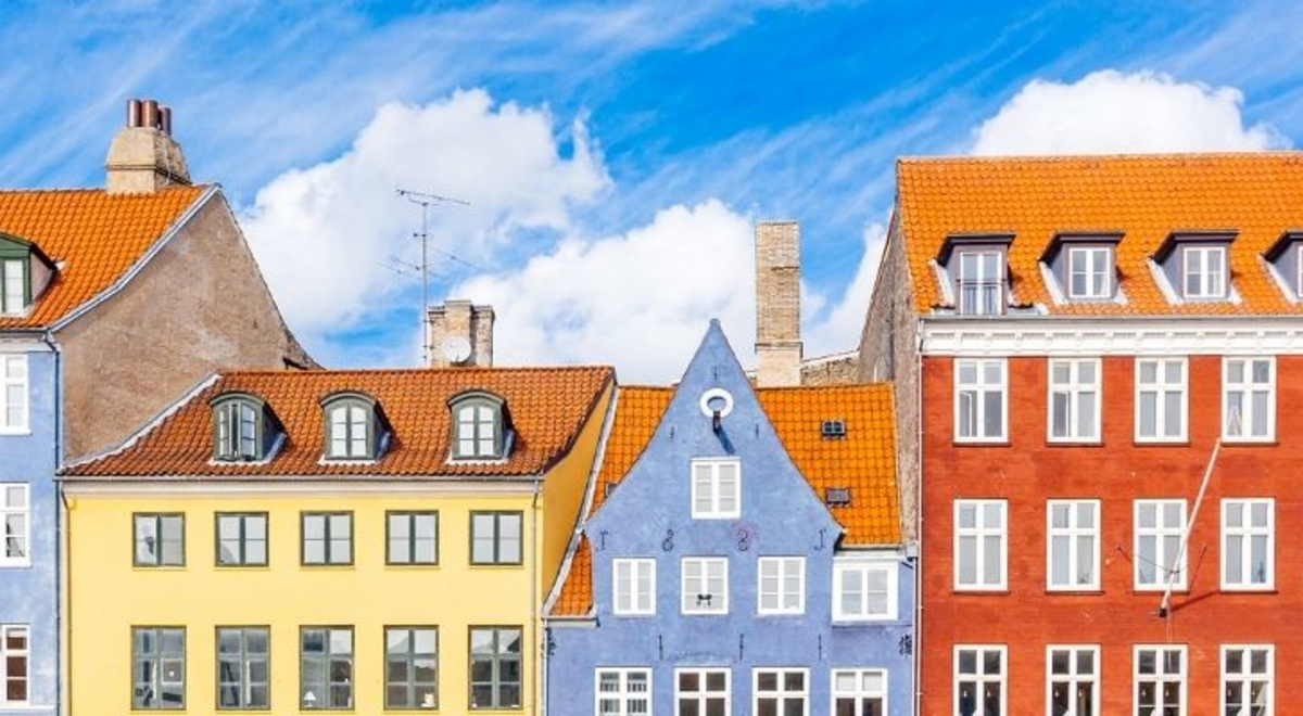 Multiple houses in different colors located in  Nyhavn Harbor