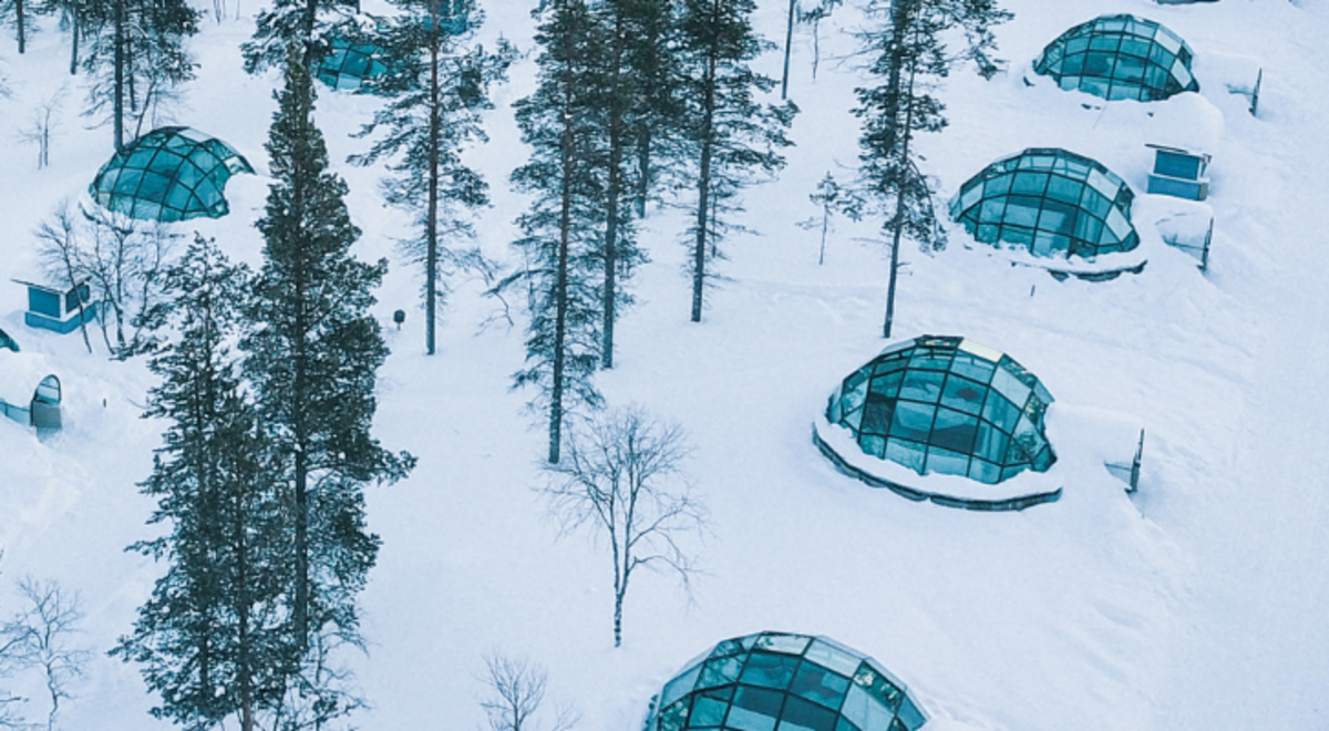 Kakslauttanen Arctic Resort East Village, glass made tents surrounded by snow in the middle of the forest