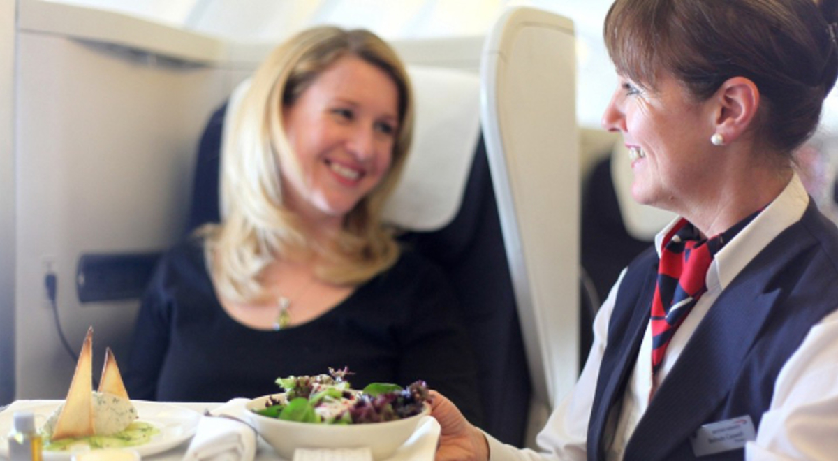 Air hostess serving food to a passenger  