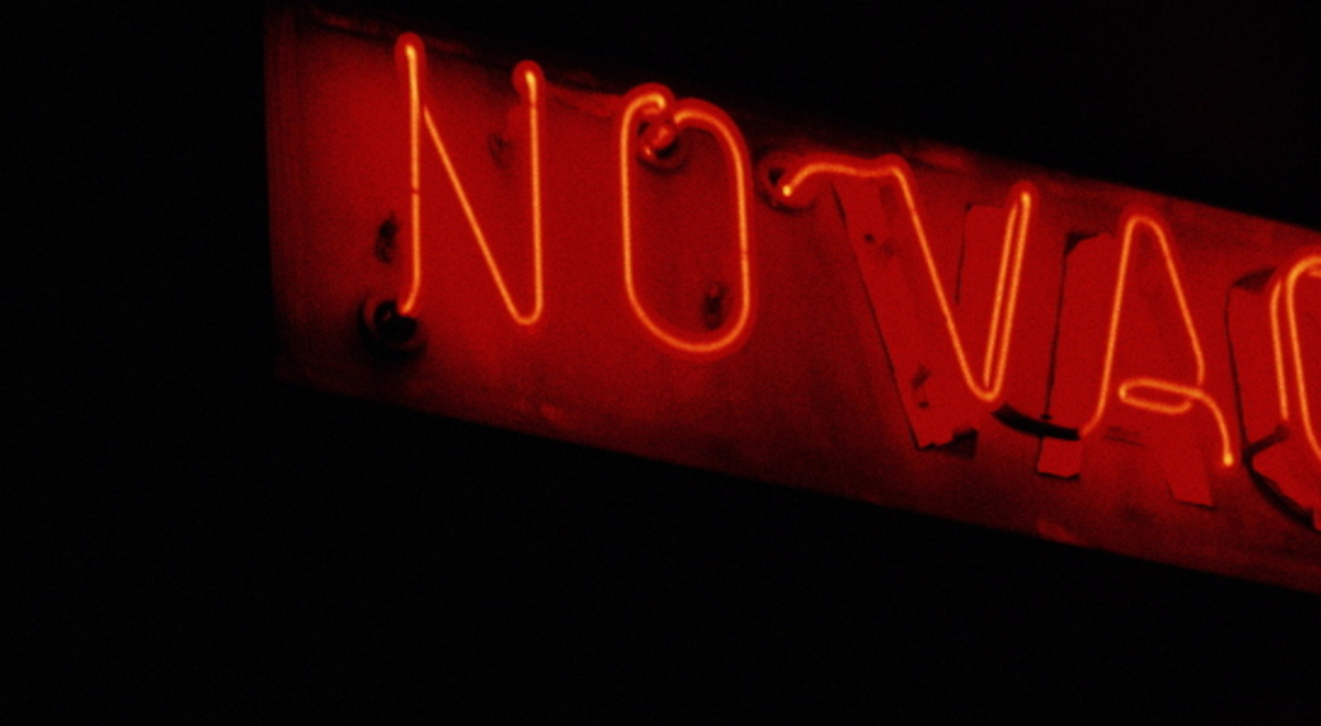 No vacancy indicated by a red neon light sign