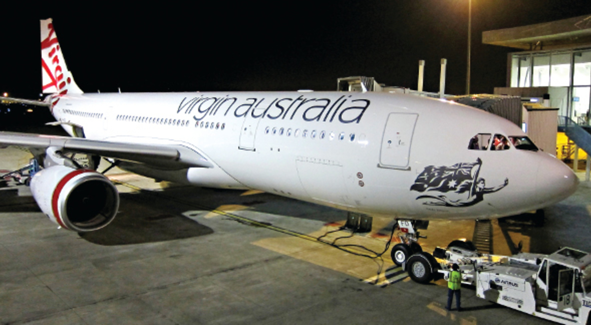 crew conducting maintenance on one of Virgin Australia's plane parked in the airport