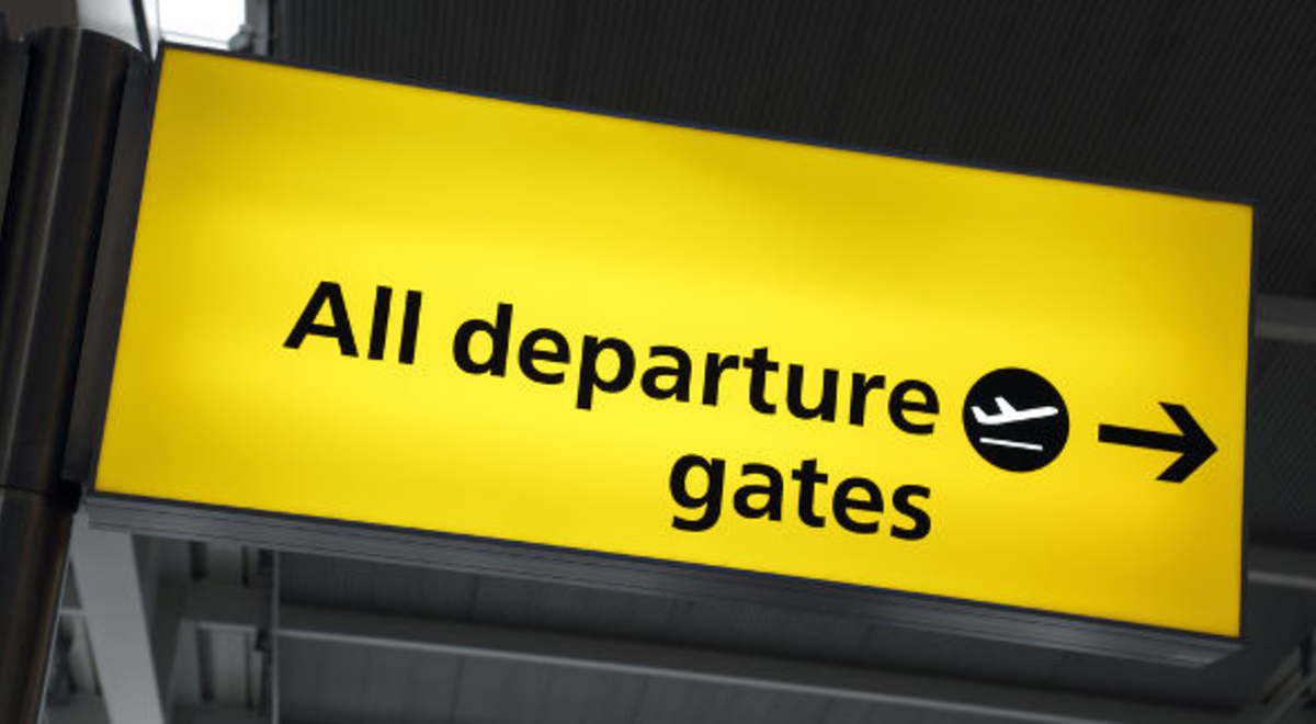 Bright yellow departure gate airport sign