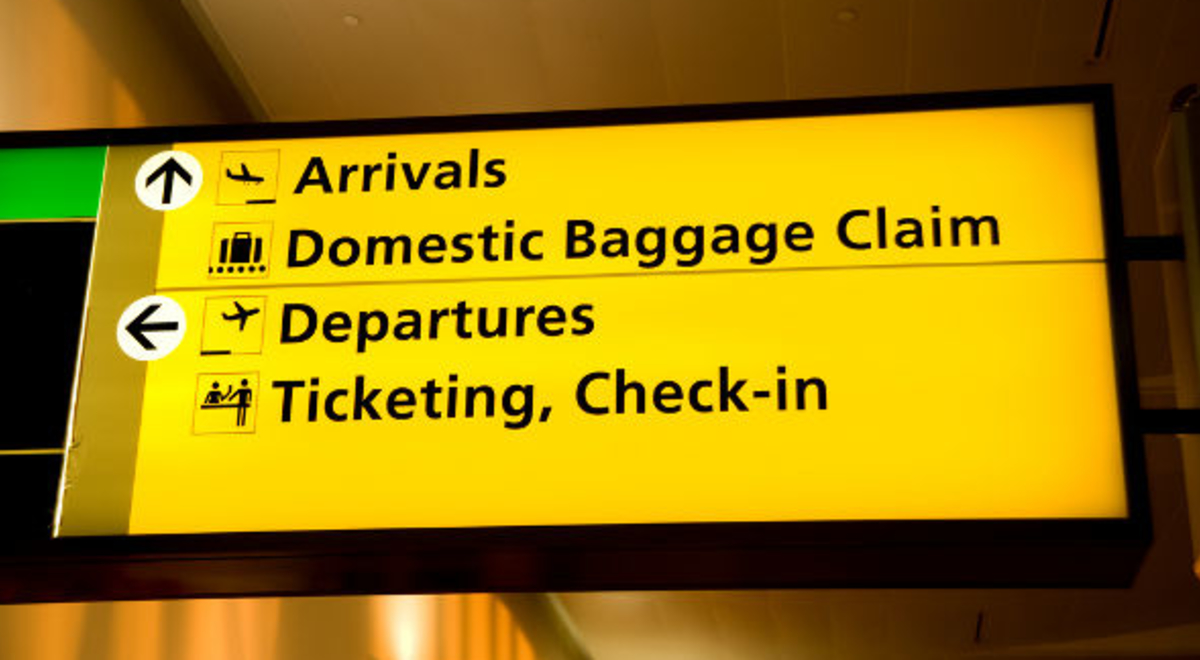 Bright yellow domestic airport direction sign