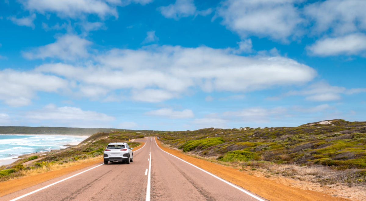 car driving along side beach