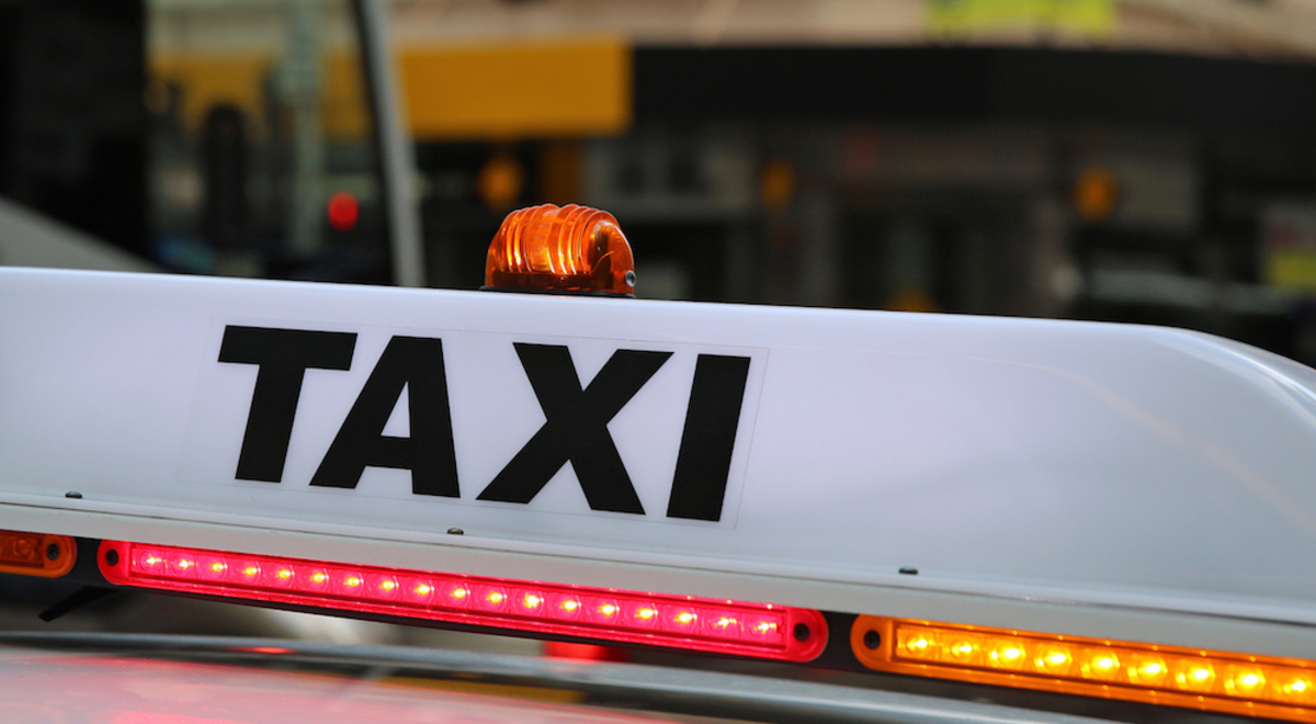 taxi signage with red and orange lights
