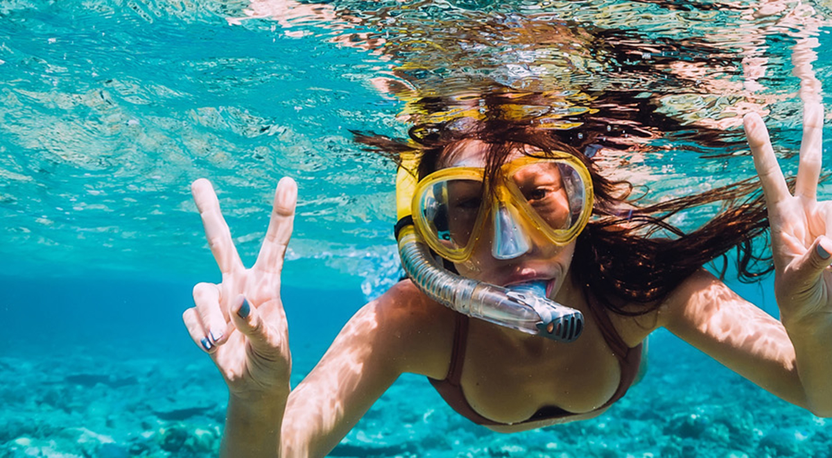 Woman enjoying snorkeling in the ocean