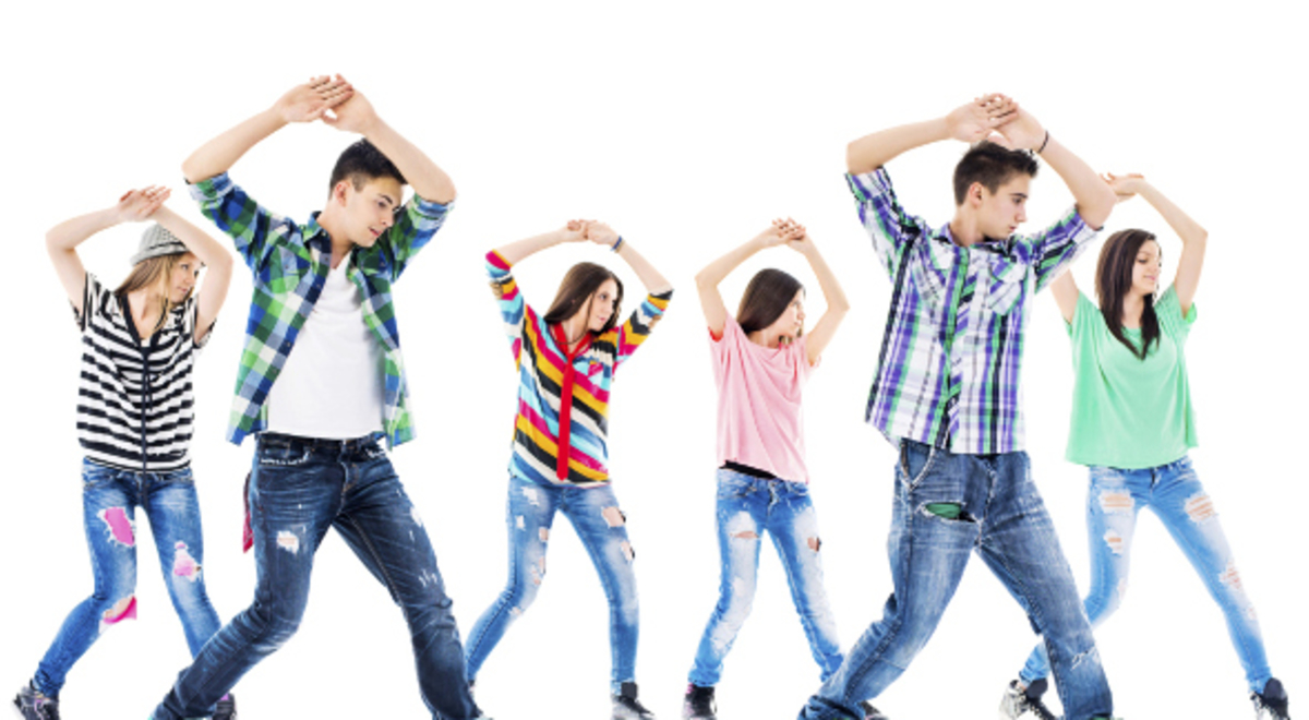 Group dancing in colorful tops and denim jeans 