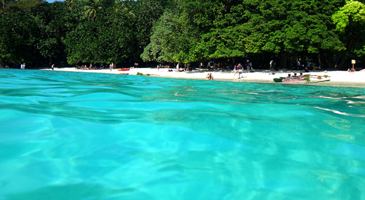 People unwinding at the shore of Champagne Bay, Vanuatu