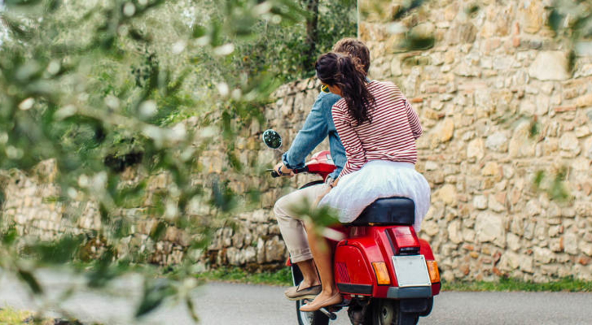 couple on moped in Italian countryside