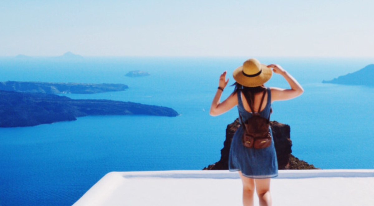 Girl admiring the view  from white village in Greece