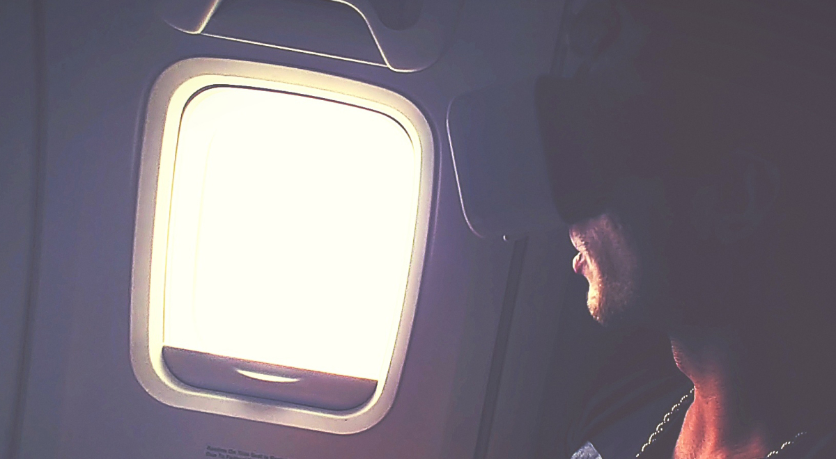 Man using a virtual reality headset on a plane