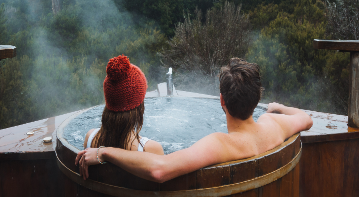 Couple relaxing in the hot tub at Peppers Cradle Mountain Lodge