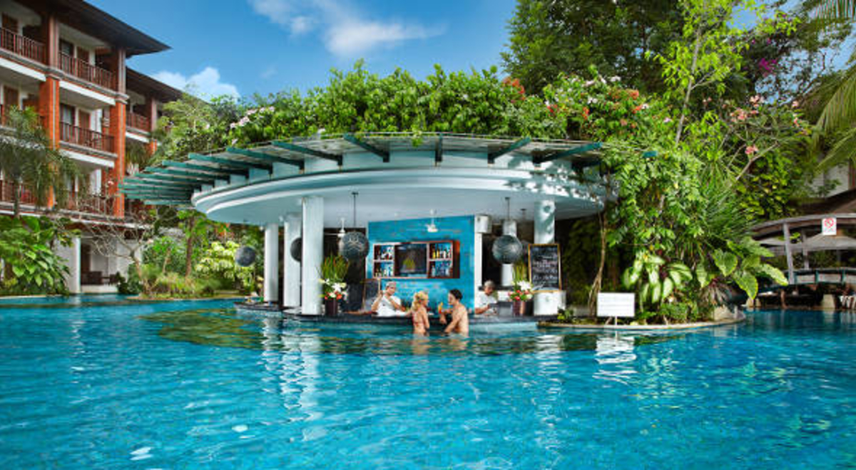 Couple enjoying the sunken bar in the pool in Padma Resort