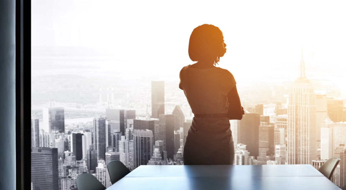 Woman looking out the window to city view 