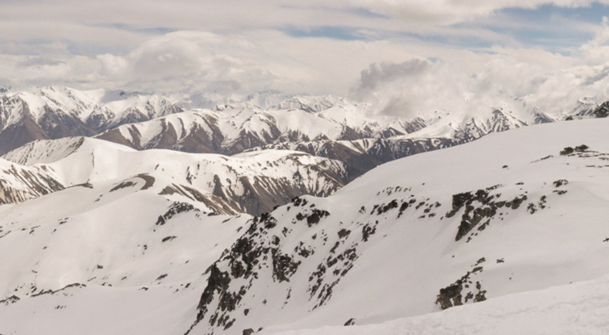 A group of people hiking on a snowy alps