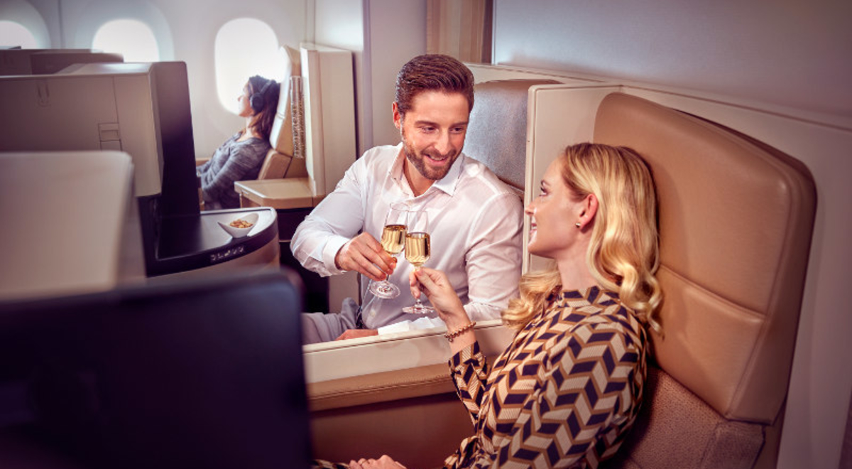 couple sharing champagne Business Class Etihad Airways