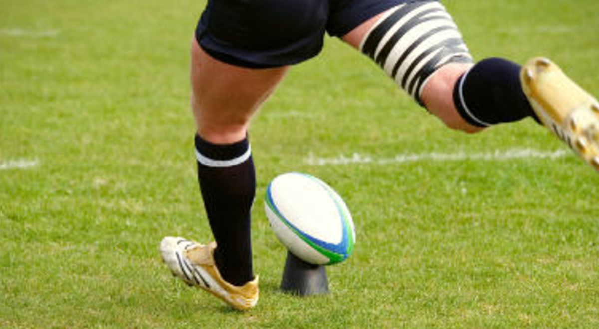 Rugby player kicking the ball 