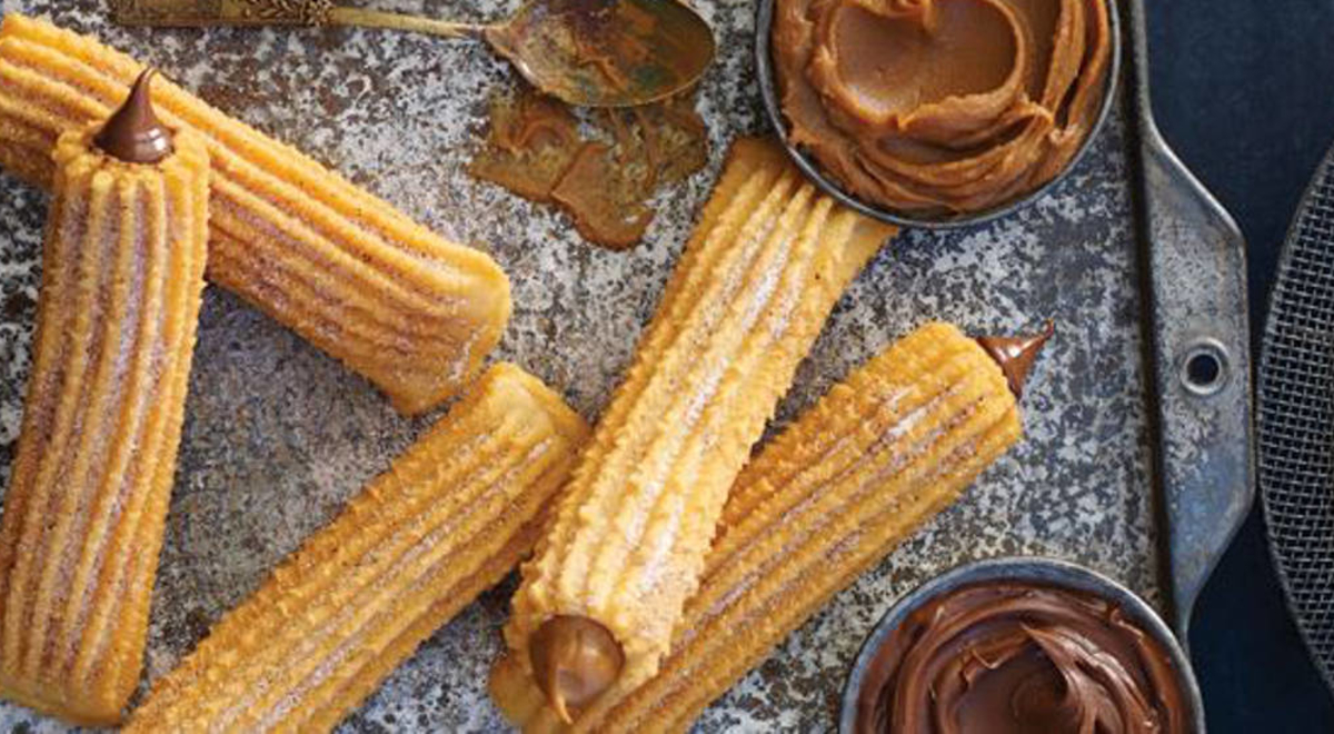 Few pieces of Churros with sweet chocolate dip